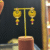 Antique Gold Temple Peacock Jhumka Earrings with Ruby Accents