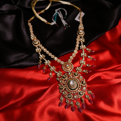 A handcrafted bridal necklace featuring Polki, Kundan, and ruby accents in royal Indian design.